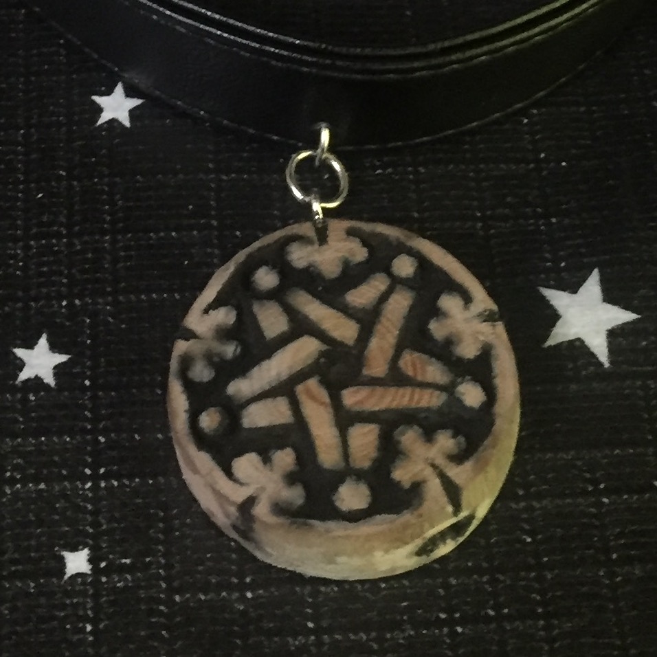 Wooden necklace with a pentagram zoomed in